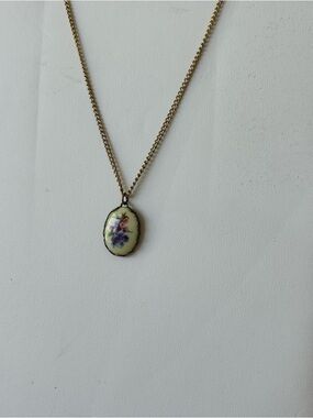 vintage oval pendant necklace featuring a floral design